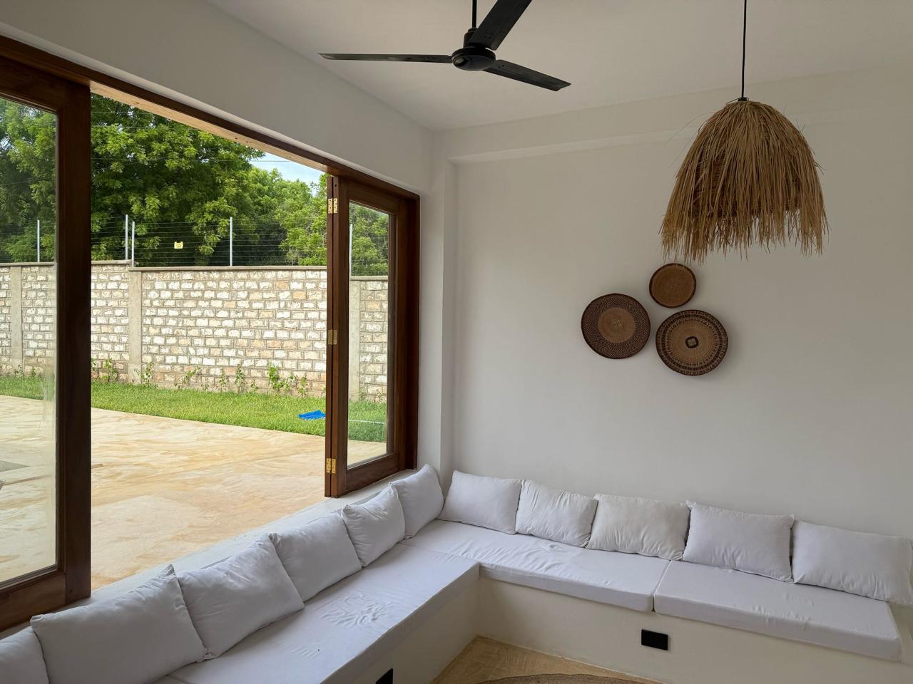 Villa Mawaka open lounge with built-in L-shape seating and hardwood sliding doors